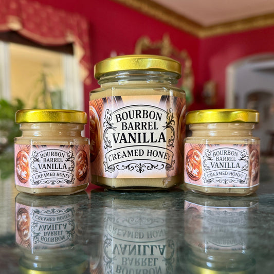 Bourbon Barrel Vanilla Creamed Honey in clear glass jar with ribbon and gold spoon – gourmet gift for bourbon lovers
